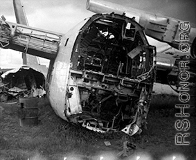 A wrecked and broken-backed B-24 bomber in a bone yard near the base.