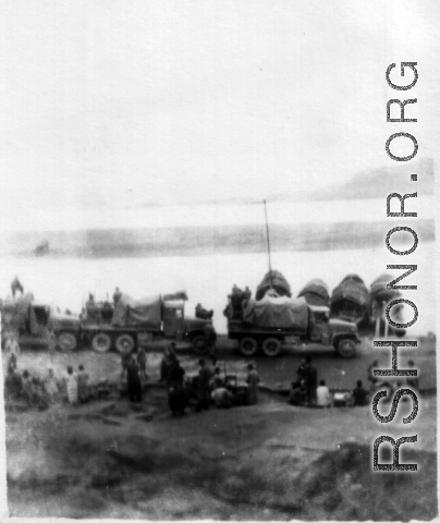 12th Air Service Group convoy waiting to cross barge in China during WWII.