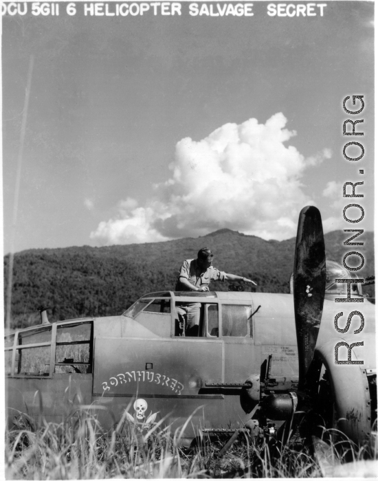 10CU 5G11 G Helicopter Salvage Secret. B-25J "Cornhusker," serial #43-3951, hard on the ground in China. A GI salvages gauges from the cockpit of the wrecked craft.