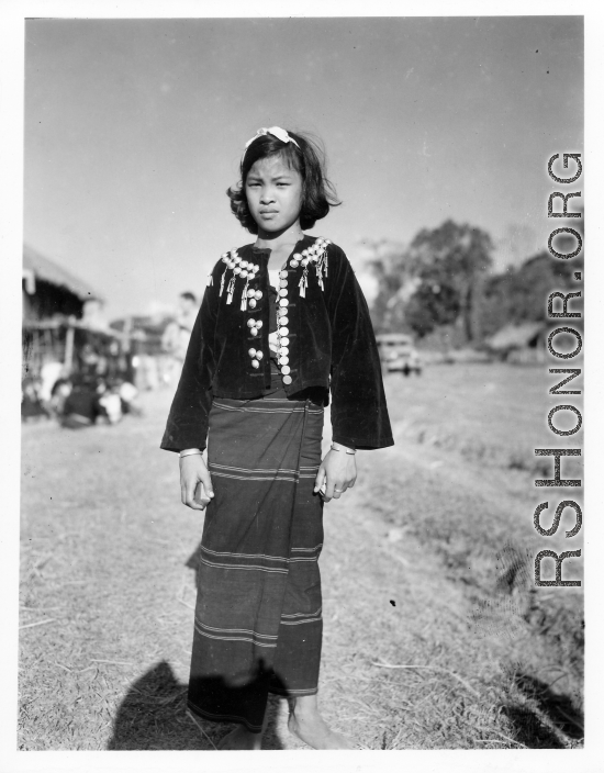 Local people in Burma near the 797th Engineer Forestry Company--A Kachin girl dress for Christmas on December 25, 1944, in Burma.  During WWII.