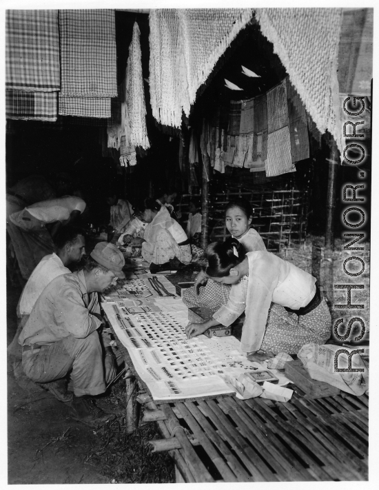 Local people in Burma near the 797th Engineer Forestry Company--A GI visits a jewel shop in Burma.  During WWII.