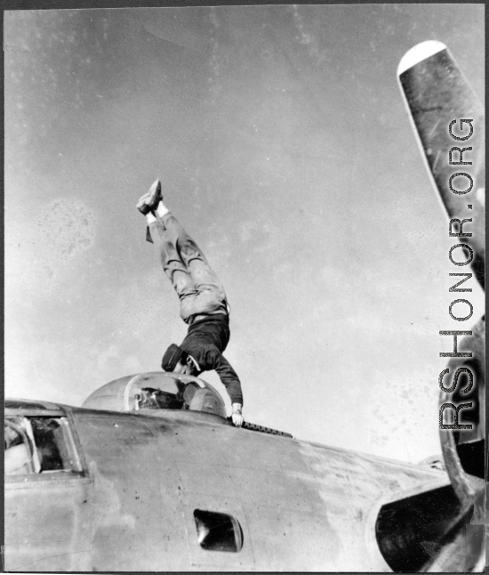 American flyer does a handstand on the two .05 cal guns of a turret on a F-7A/B-24.  24th Combat Mapping Squadron, 8th Photo Reconnaissance Group, 10th Air Force.