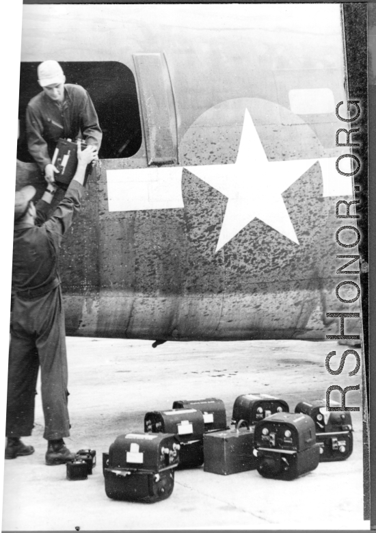 Loading film cartridges into 24th Mapping Squadron F-7A.