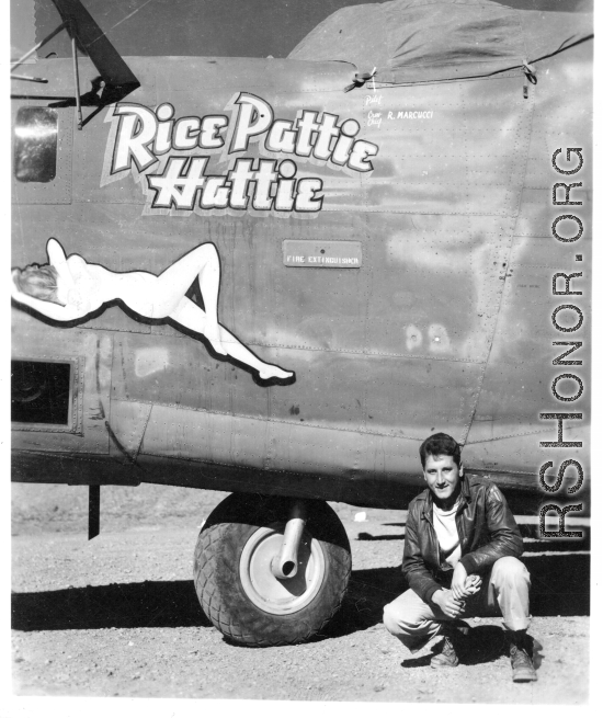 Flyer kneeling with F-7A "Rice Pattie Hattie." 24th Combat Mapping Squadron, 8th Photo Reconnaissance Group, 10th Air Force