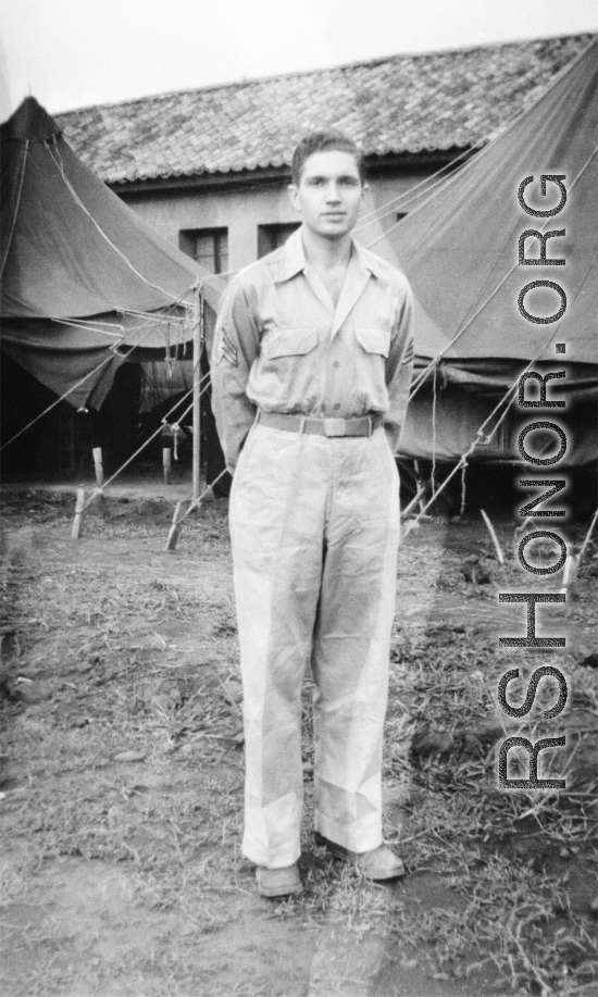 Sgt. David Axelrod, was in the 23rd Fighter Control Squadron from January to August, 1945, stationed at its headquarters at Luliang Airbase, Yunnan, China.  Here he is standing in front of the headquarters tents and building.  