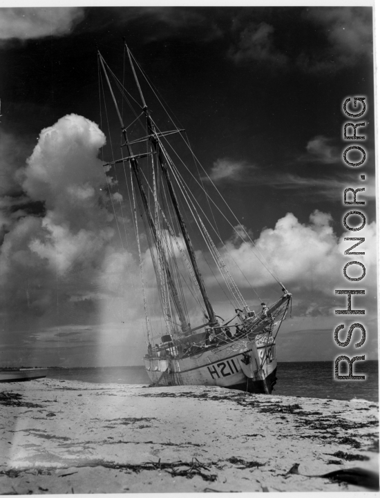 Boat 'Icaros", #H211, aground on the sandy shore in India.  Scenes in India witnessed by American GIs during WWII. For many Americans of that era, with their limited experience traveling, the everyday sights and sounds overseas were new, intriguing, and photo worthy.