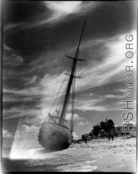 Boat 'Icaros" ground on the sandy shore in India.  Scenes in India witnessed by American GIs during WWII. For many Americans of that era, with their limited experience traveling, the everyday sights and sounds overseas were new, intriguing, and photo worthy.