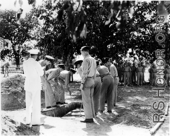Solemn burial ceremony for American GIS who had died at a temporary war-time graveyard. In the CBI, during WWII.