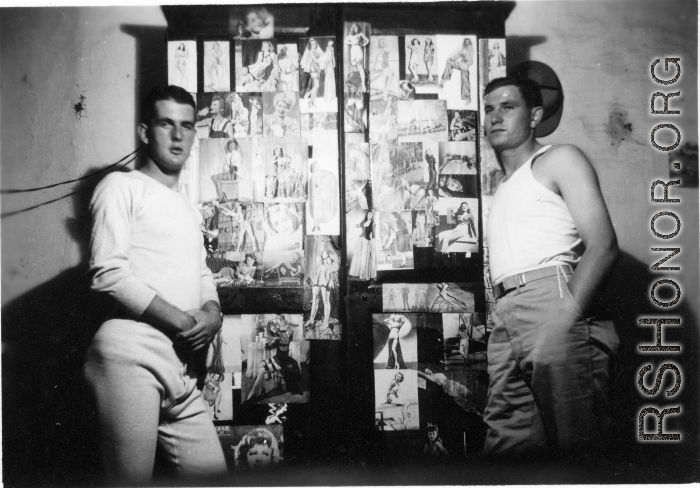 View inside barracks for two GIs in Yunnan, China, during WWII--here a wardrobe covered in pin-up girls.