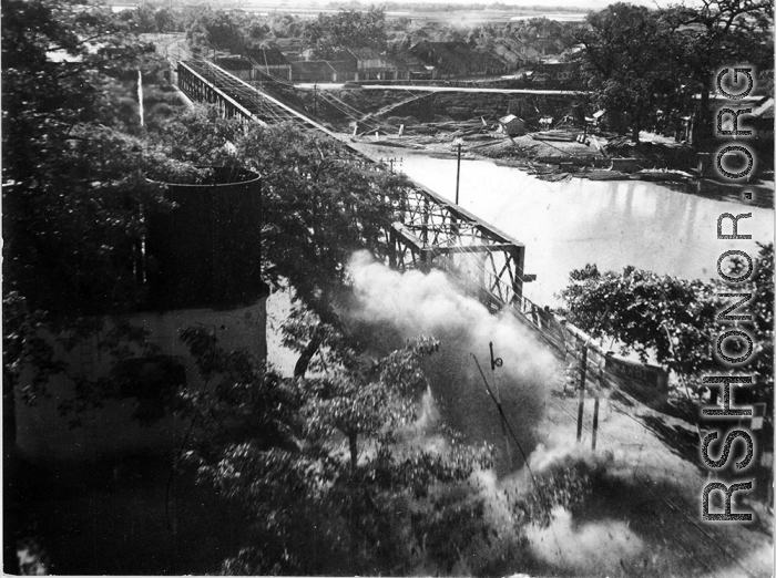 Bombing on Phu Lang Thuong railway bridge over the Thuong River at Bắc Giang City in French Indochina (Vietnam), during WWII. In northern Vietnam, and along a critical rail route used by the Japanese.  Coordinates:  21°16'32.69"N 106°11'9.28"E  This photo shows the truly extraordinarily low levels the bombing B-25s sometimes flew at times during missions.