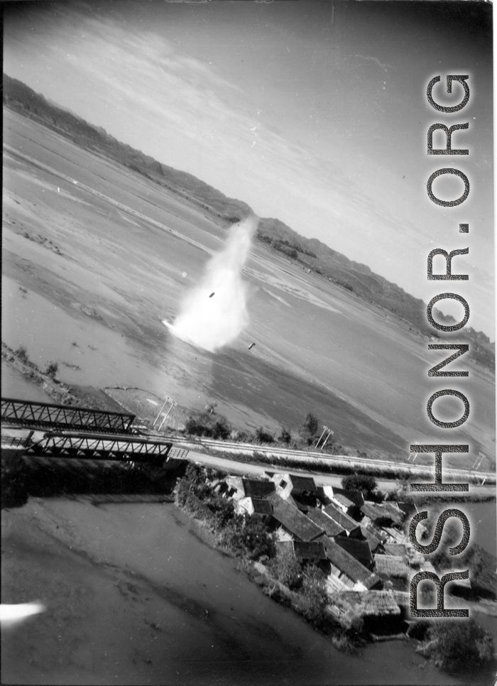 Bombing of small rail bridge, among a flood plain, in French Indochina during WWII.