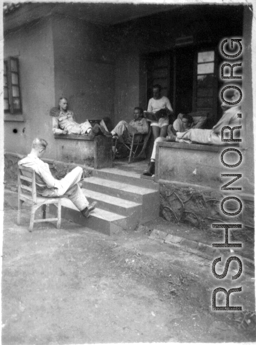 GIs resting at barracks area, likely at Yangkai, during WWII.  Smiley on right.