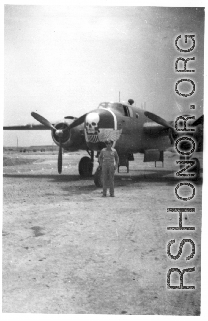 An oversized "Skull & Wings" insignia on plane's side near the nose indicates this parked B-25J Mitchell is assigned to 490th Bomb Squadron, 341st Bomb Group.  The 490th had stayed in India, attached to Tenth Air Force, when 341st BG moved from to China in January 1944. With aerial combat finished in Burma, the 490th BS (attached to 312 Fighter Wing) moved in late April 1945 to Hanzhong (Han-chung), southwestern Shaanxi Province, central China.  (Additional information courtesy of Tony Strotman.)