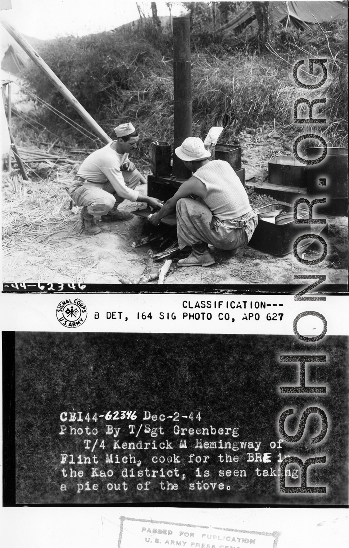 T/4 Kendrick M. Hemingway, cook for the BRE in the Kao district, si seen taking a pie out of a stove in the field.  December 2, 1944.  Photo by T/5 Milton Koff. 164th Signal Photographic Company, APO 627.