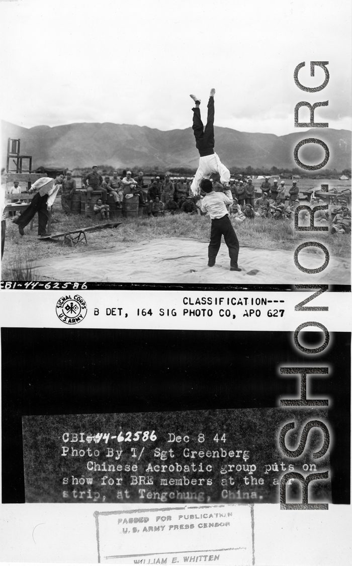 Chinese acrobatic group puts on show for Burma Road Engineers (BRE) members at the air strip, at Tengchong, China.  December 8, 1944.  Photo by T/Sgt. Greenberg. 164th Signal Photographic Company, APO 627.  Passed by William E. Whitten.
