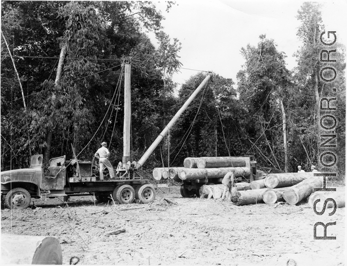797th Engineer Forestry Company mill in Burma, loading logs for milling for bridge building along the Burma Road.  During WWII.