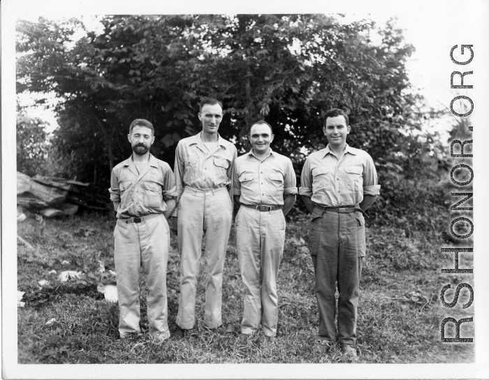 Engineers of the 797th Engineer Forestry Company pose before trees in Burma.  During WWII.