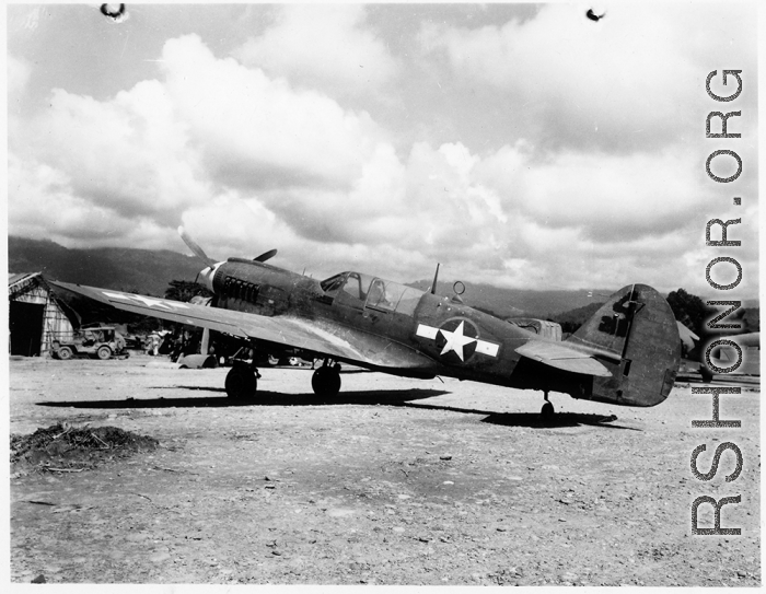A P-40 fighter at an airstrip in Burma.  Aircraft in Burma near the 797th Engineer Forestry Company.  During WWII.