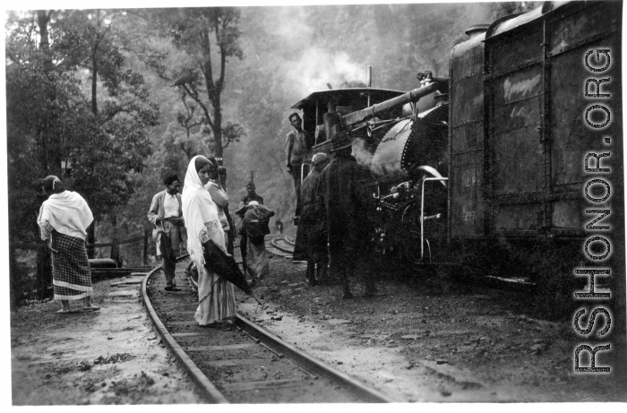 Darjeeling Himalayan Railway (DHR) B Class 2 ft. saddle tank steam locomotive in the mountains, on winding track.