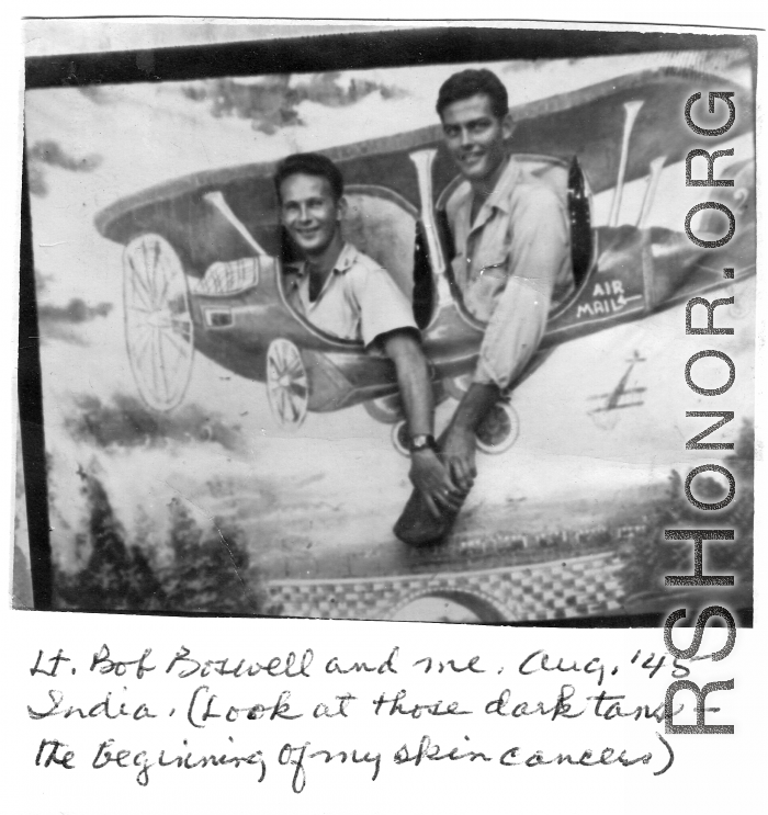ATC flyers Lt. Bob Boswell and Richard Harris pose in fake prop airplane wall in India, during WWII, in August 1945.
