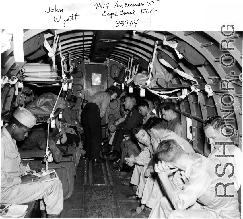 GIs and flight nurse (probably) on a transport plane. In the CBI during WWII.