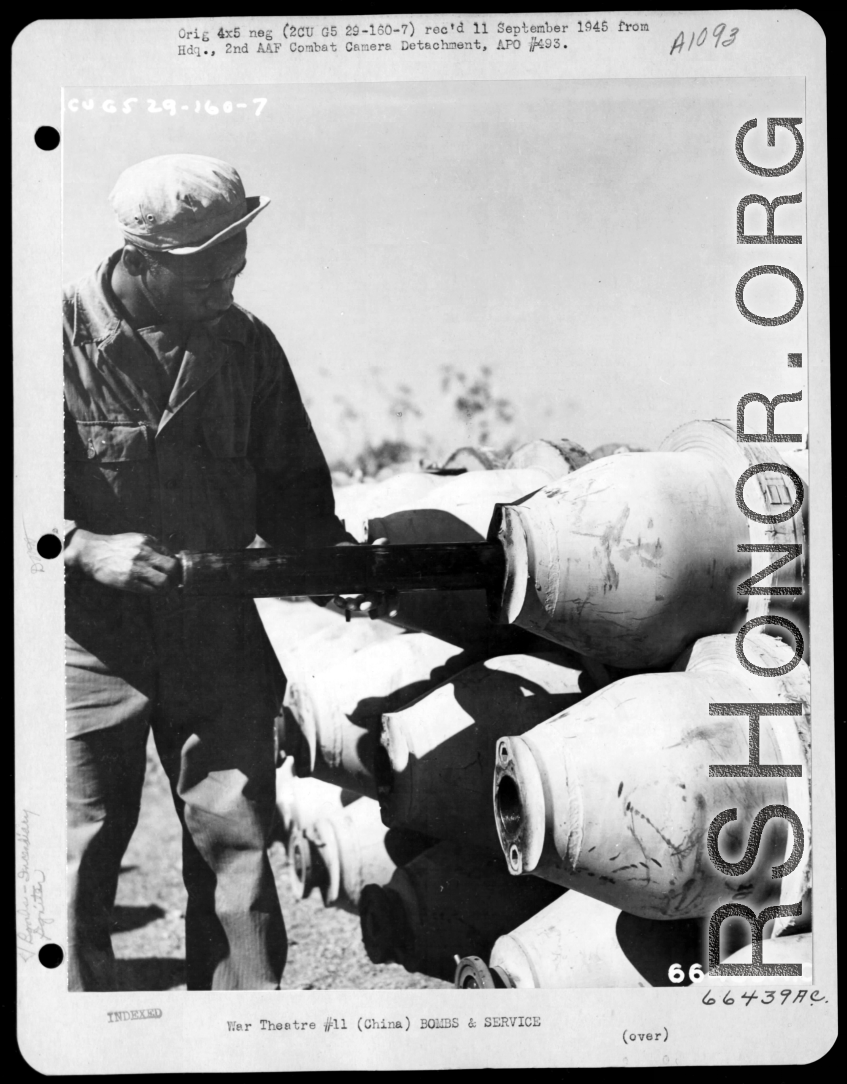 An African-American serviceman inserts the M-5 igniter into the burster well of the a M-76 500-pound incendiary bomb, making certain that the pipe lugs of the igniter are to the rear. China.