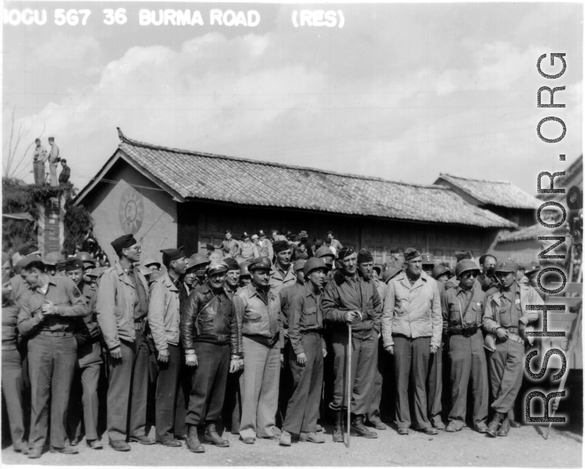 10CU 567 36 BURMA ROAD (RES). Soldiers at ease in China, waiting for arrival of a convoy over the Burma Road or listening to a commemorative speech about the opening of the road. A movie camera is set to go on the truck to the right.