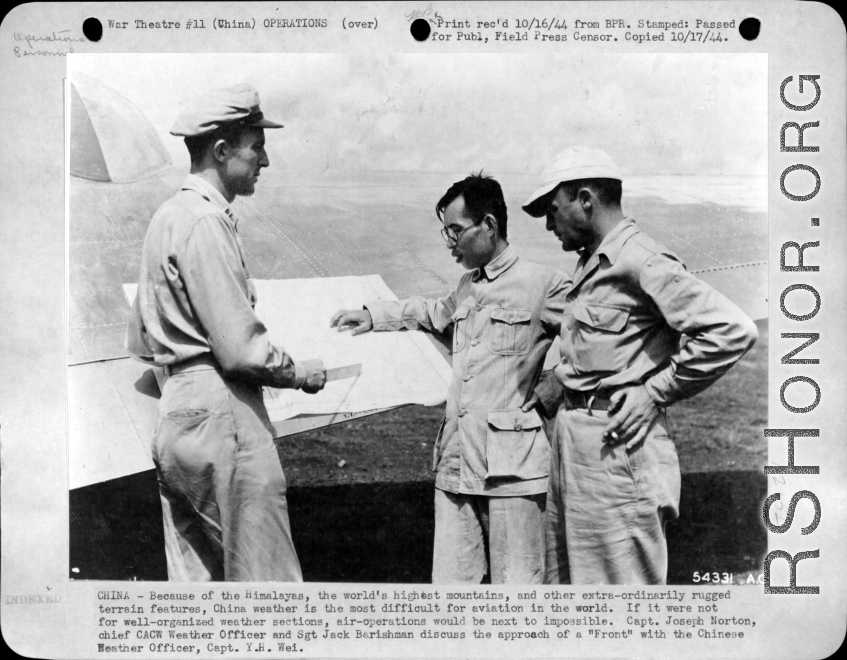 Capt. Joseph Norton, chief CACW Weather Officer, and Sgt. Jack Barishman discuss the approach of a "front" with Chinese Weather Officier, Capt. Y. H. Wei.