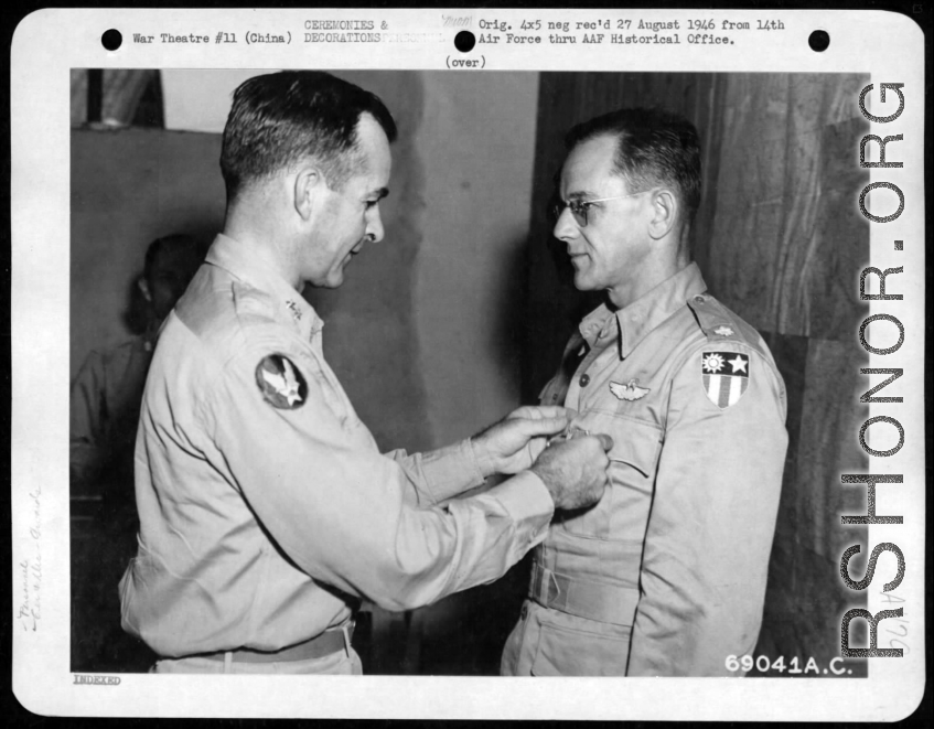 Lt. Colonel William D. Hopson Of Little Rock, Arkansas, Squadron Commander In A Heavy Bomber Group Of The "Flying Tigers", Receives The Distinguished Flying Cross From Major General Charles B. Stone At A 14Th Air Force Base In China. 19 September 1945.