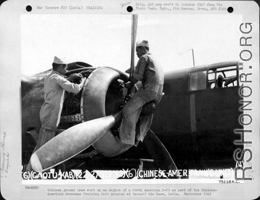 Chinese ground crew work on an engine of a B-25 as part of the Chinese-American Overseas Training Unit program at Karachi Air Base, India. September 1943.