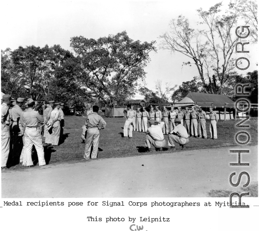 Medal recipients pose for Signal Corps photographers at Myitkina.  Photo form C. W. Leipnitz.