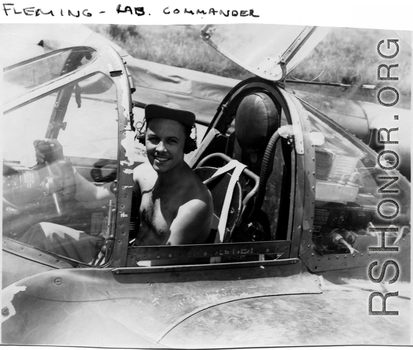 A GI sits in the cockpit of a reconnaissance F-5 (P-38) in the CBI. "Fleming- Lab. Commander."