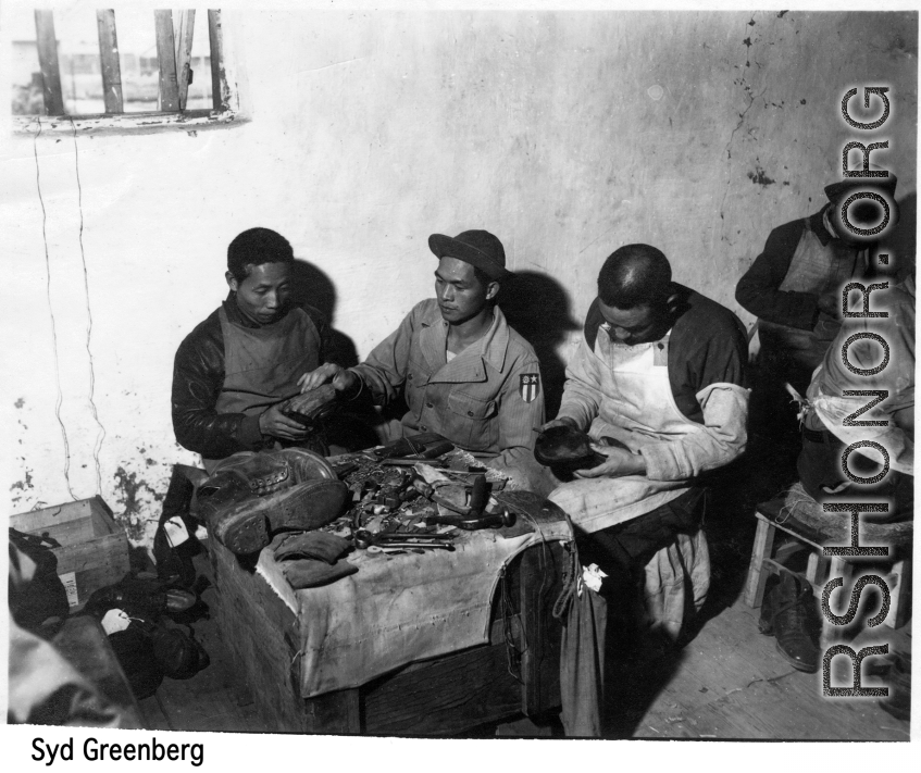 Chinese cobblers working on shoes. In the CBI during WWII.   Photo by Syd Greenberg.
