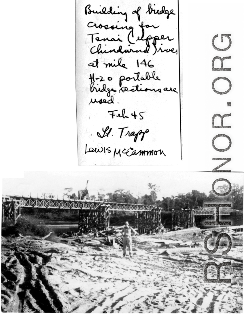 Lt. Trapp standing in front of bridge over Tenai River being built by GIs from H-20 portable bridge sections. February 1945.  Photo provided by Lewis. McCammon.