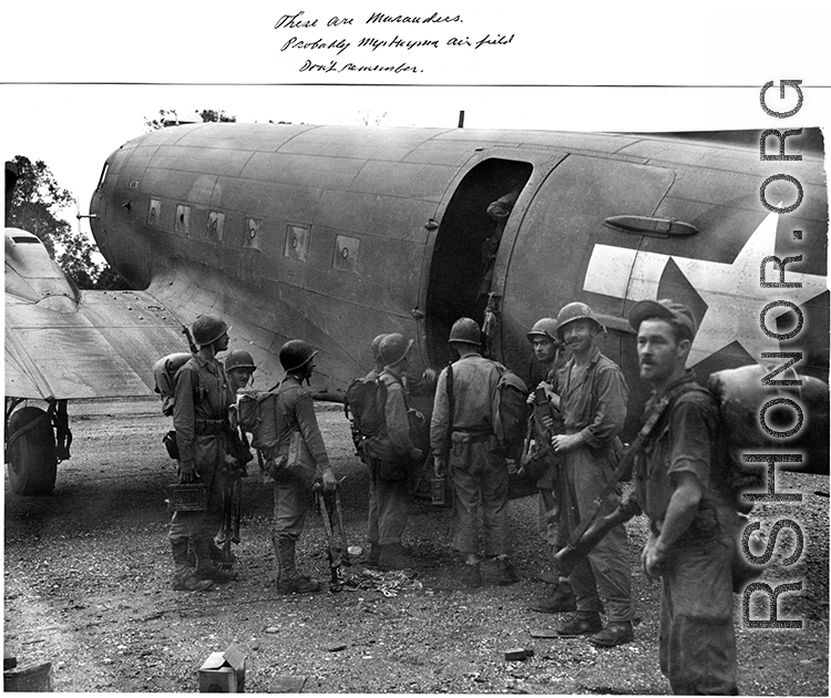 Tired Merrill's Marauders queuing up to board a C-47 transport plane, probably at Myitkyina, Burma. During WWII.