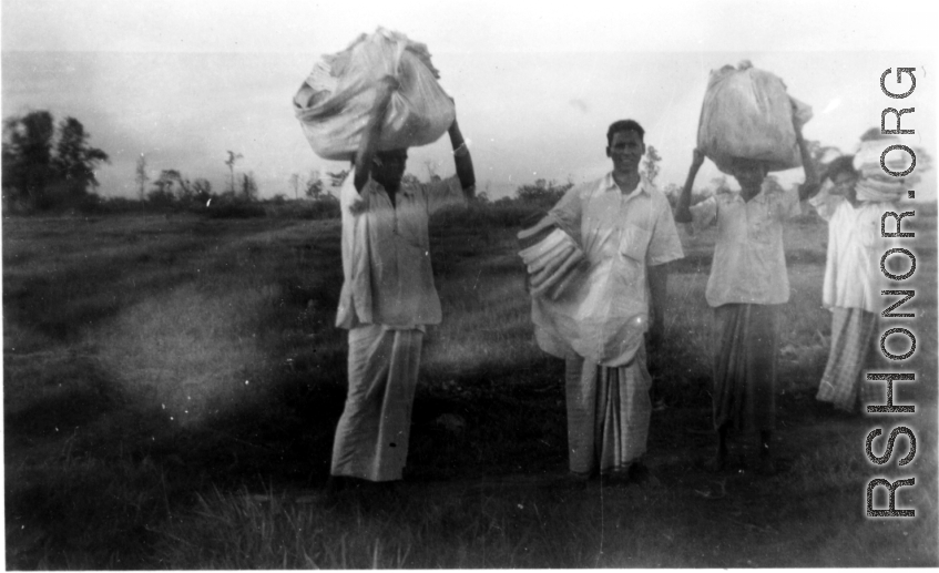 Men carrying laundry in India during WWII.  Local images provided to Ex-CBI Roundup by "P. Noel" showing local people and scenes around Misamari, India.  