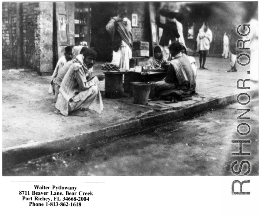 People selling something on the sidewalk in India, during WWII.  Photo from Walter Pytlowany. 