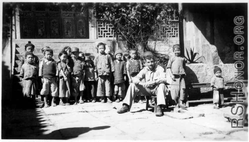 School kids in the school courtyard, with Fred Nash, 10 miles east of Yangkai, Spring of 1945.  From the collection of Frank Bates.