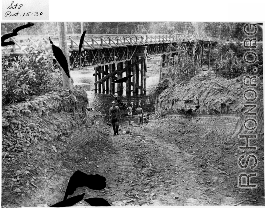 GIs bathe by American-made bridge in Burma (or India), during WWII.  Image provided by Emery and Beth Vrana.