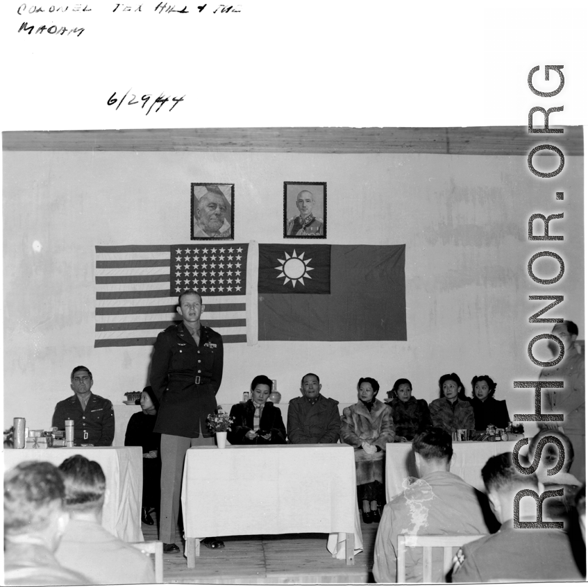 Colonel Tex Hill addresses a crowd on June 29th, 1944, while Madam Chiang Kai-shek looks on.