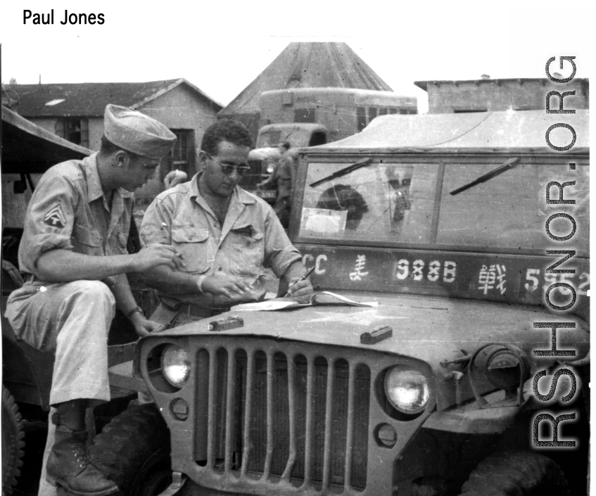 GIs strategize over the hood of a jeep in the CBI.  Photo from Paul Jones.
