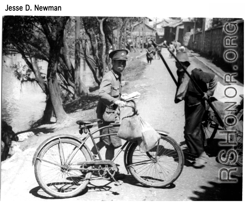A Chinese postman delivers wartime mail by bicycle, during WWII.  Photo from Jesse D. Newman.