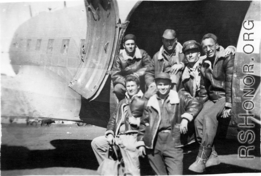 GIs lounge at the loading door of a C-47 transport plane in China during WWII during evacuation because of Ichigo: "We Were Forced To Evacuate Our Base At Kwelin, China And This Is A Pic Of Some Of The 396th Guys Loading On A C-47 To Get Out Of There. Standing: Weidenbrenner, and Reese. L/R In Plane: Souder, O'Connor, Rodriguez, and Wolfe."