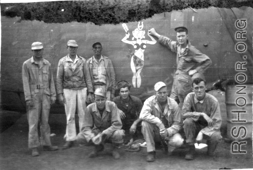 A group of GIs poses before salvaged fuselage of B-24 bomber "Lady Luck II" at Ankang, China, during WWII: "This Is A Group Of 396th Guys I Think At Ankang, China. Kneeling: O'Connor, Wander, Hanson, and Caples. Standing: Euler, Schmidt, Besson, and Tacey."