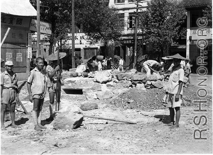 Chinese workers and Nationalist soldiers build a fortified bunker at a street corner in a town in Guangxi province, during WWII, in the summer or fall of 1944 during the Japanese push south in the Ichigo campaign.