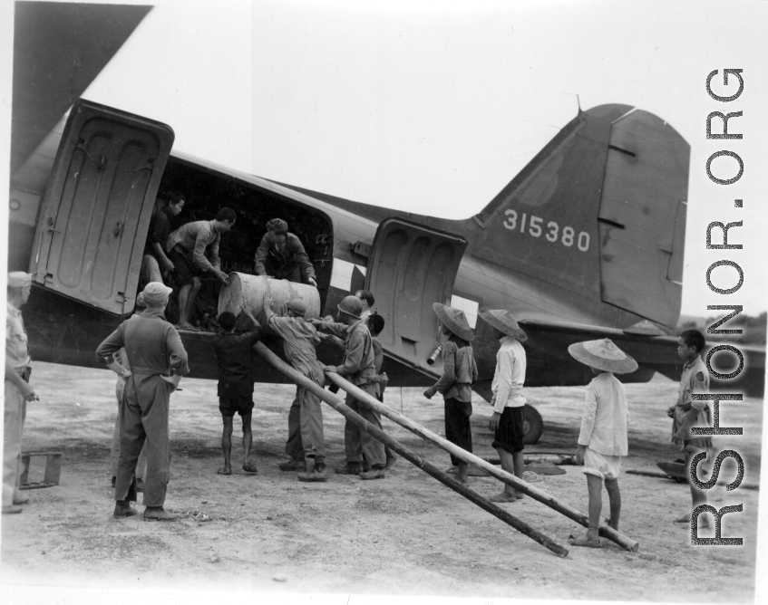 Unloading (or loading) fuel barrels from C-47 transport plane #315380 in China during WWII. Note how some of the Chinese laborers are just teenagers, and overshadowed by the much larger adult American soldiers.