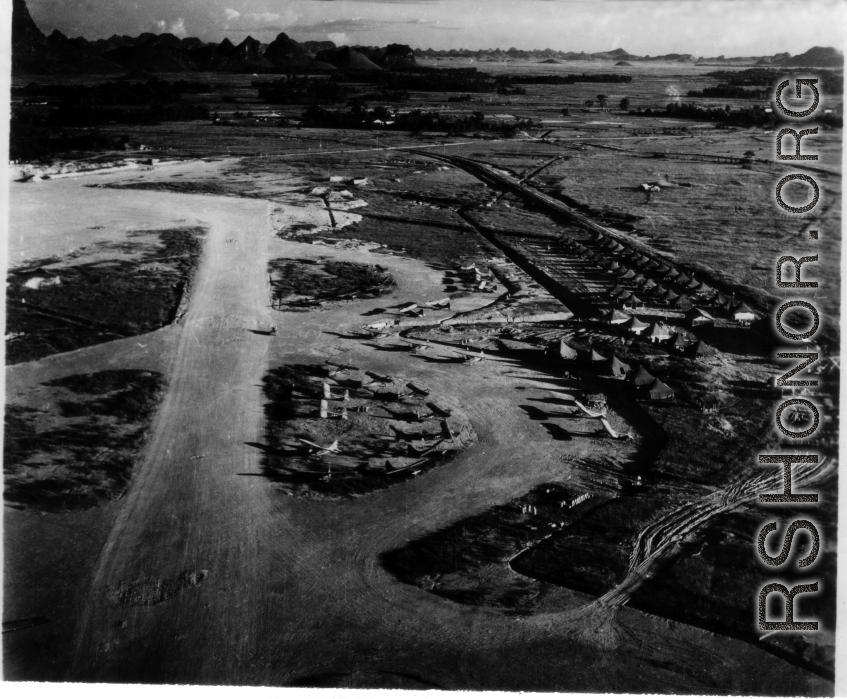 L-6s, and other planes at the Liuzhou (Liuchow) air base during the summer or fall of 1945. Rows of tents are on the right. The distinct karst mountains of the area are visible in the background.  Photos taken by Robert F. Riese in or around Liuzhou city, Guangxi province, China, in 1945.
