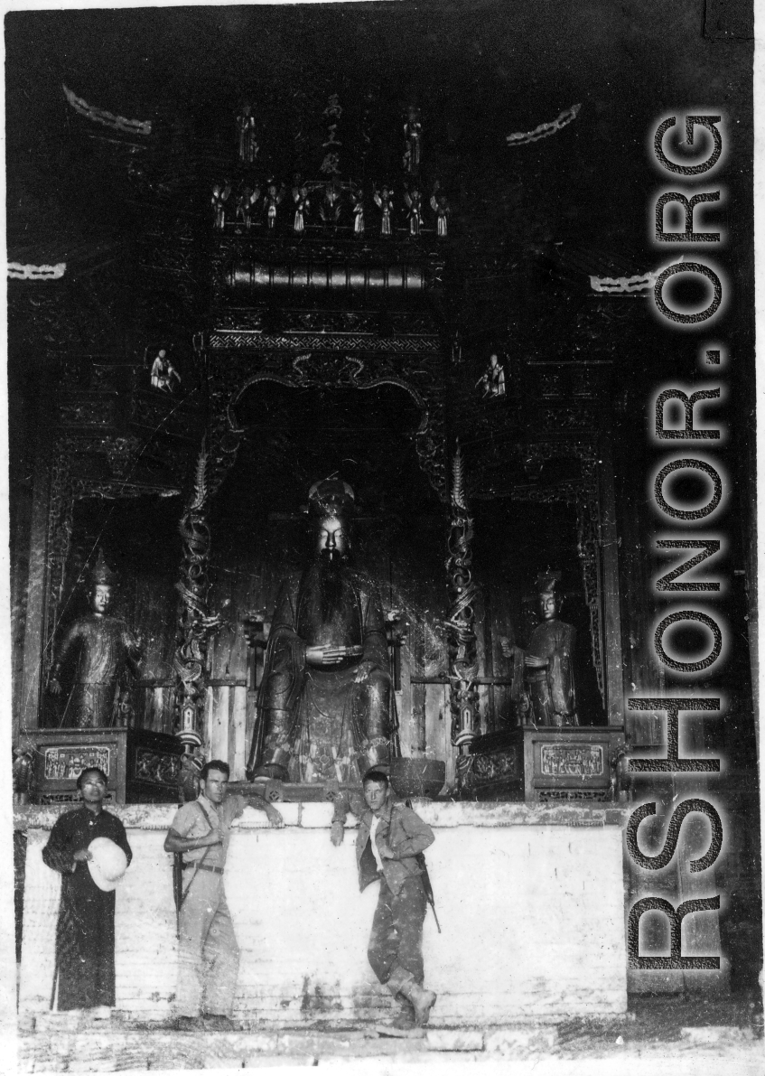 GIs and Chinese man inside a temple in China, probably at Confucian or Daoist temple. During WWII.
