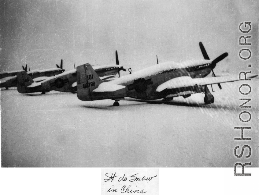Several P-51s in a row after snowfall at a base in the CBI during WWII, the closest with tail #410788.