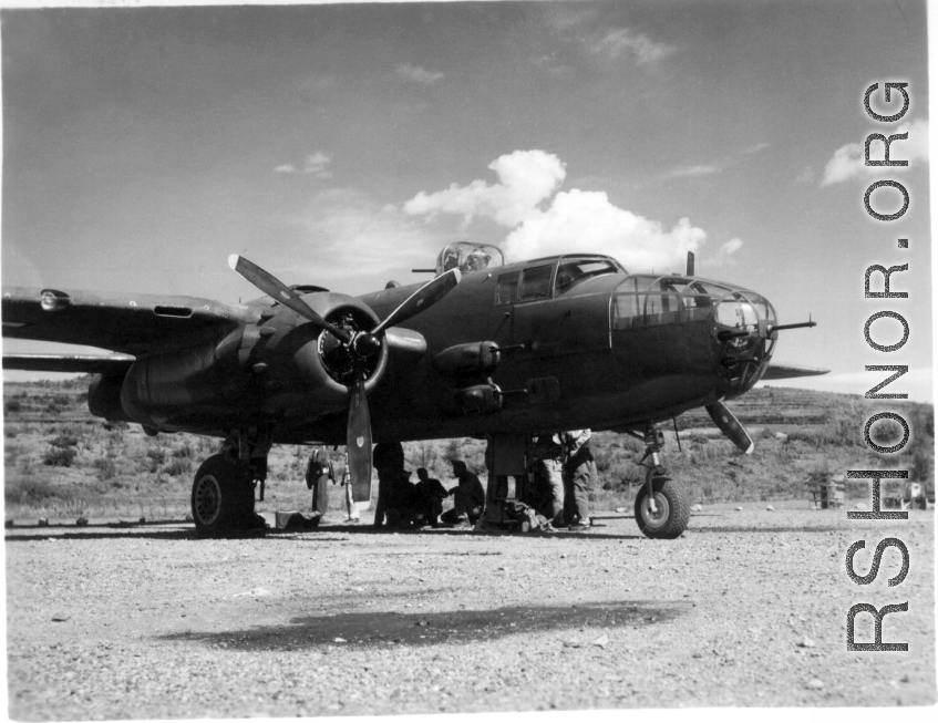 B-25 and crew at Yangkai, late 1944? Looks like 436 (same as large group picture) just coming in new to the squadron.  The big guy kneeling (in silhouette) with the cap brim up is A.B. Christensen.  From the collection of Frank Bates.